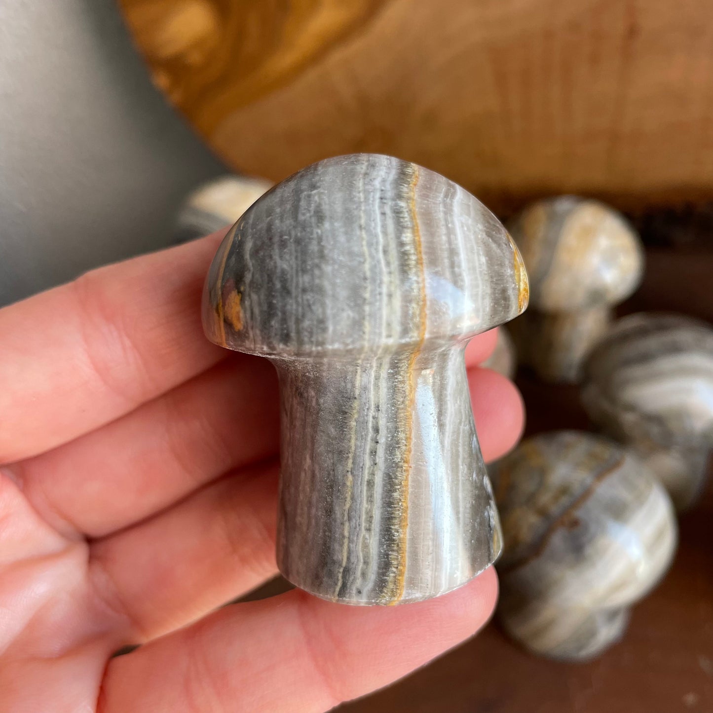 Elevate your energy with the mesmerizing stripes of our Zebra Calcite Mushroom. A grounding masterpiece standing at 1.75-2" tall, it adds a touch of earthy elegance to your crystal collection.